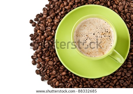 coffee beans and green cup of cappuccino isolated on a white background