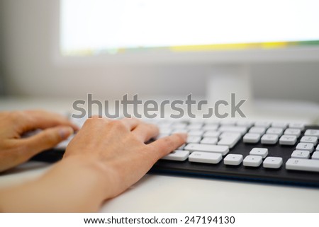 Woman hands typing on a computer keyboard.