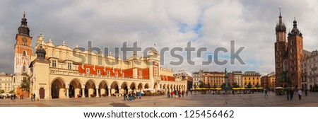 KRAKOW, POLAND - OCTOBER 11: Old market square with tourists on October 11, 2012 in Krakow. It\'s a principal urban space located at the center of the city and largest medieval town square in Europe.