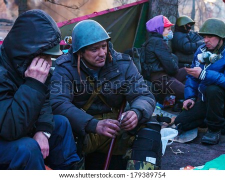KIEV, UKRAINE - FEBRUARY 20: People at the barricade on February 20, 2014 in Kiev, Ukraine. The protests were provoked when the Ukrainian president denied to sign an agreement with the EU.