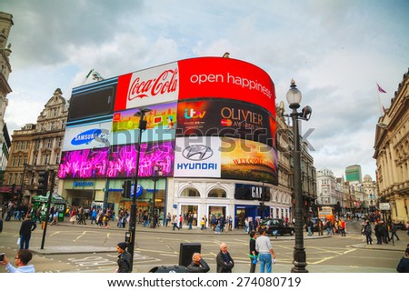LONDON - APRIL 12: Piccadilly Circus junction crowded by people on April 12, 2015 in London, UK. It\'s a road junction and public space of London\'s West End in the City of Westminster, built in 1819.