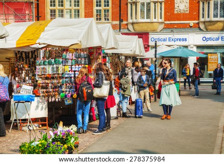 CAMBRIDGE, UK - APRIL 9: Street souvenir shops at the Market square on April 9, 2015 in Cambridge, UK. Cambridge is most widely known as the home of the University of Cambridge, founded in 1209.