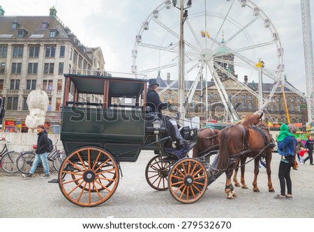 AMSTERDAM - APRIL 16: Horse cart at Dam square on April 16, 2015 in Amsterdam, Netherlands. It\'s the capital city and most populous city of the Kingdom of the Netherlands.
