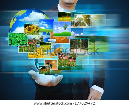 businessman holding green Earth in hands and Reaching images streaming .Environmental concept