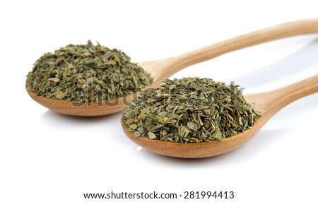 dried parsley in wooden spoon on white background