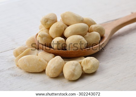 peanuts in spoon on white wooden