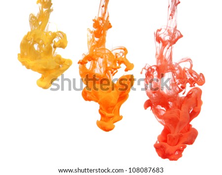 Yellow and Orange Ink dropped into water isolated on white