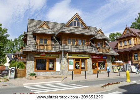 ZAKOPANE, POLAND - JULY 13, 2014: The Building in regional architecture style, on the ground floor offers its services facility of Kasa Stefczyka and Pharmacy, located in the City center