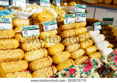 ZAKOPANE, POLAND - MARCH 09, 2015: Sales of sheep cheeses named oscypek from the street stall at Krupowki, since February 02, 2007 oscypek is Polish regional product protected by EU law