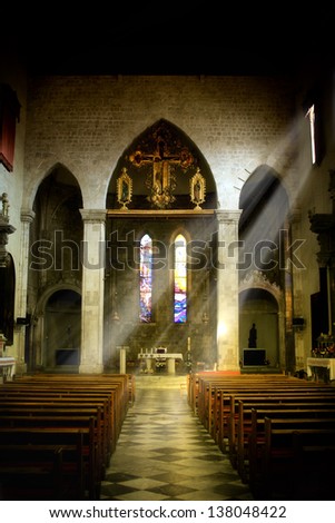 Interior of old church in Dominican monastery in Dubrovnik, dark interior with rays of light shining through the window
