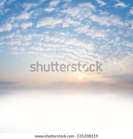 Beautiful sunrise with clouds and sun reflection in water with place for your text