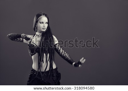 Black and white close up of beautiful, young woman performing tribal dance