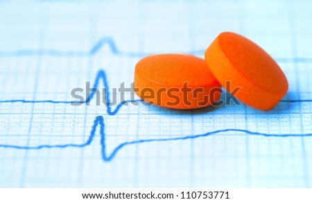 Medicine. pair of orange tabs on the cardiogram