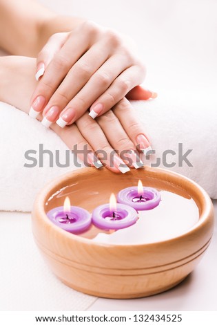 french manicure  with aromatic candles and towel