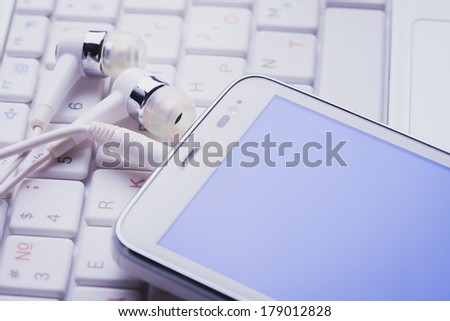 smartphone with headphones on the keypad