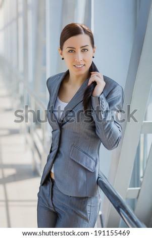Portrait of pretty businesswoman on the modern background