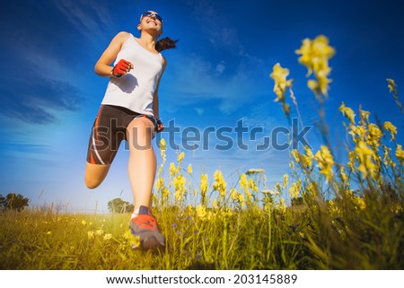 Young woman jogging in the summer park