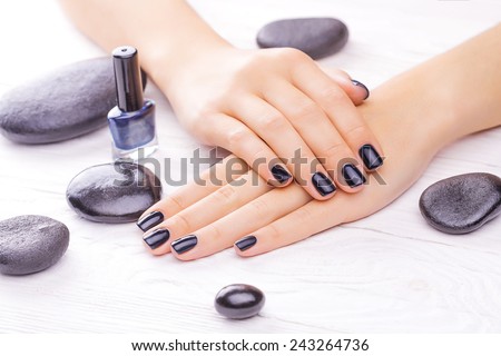 beautiful black manicure with black stones on the white