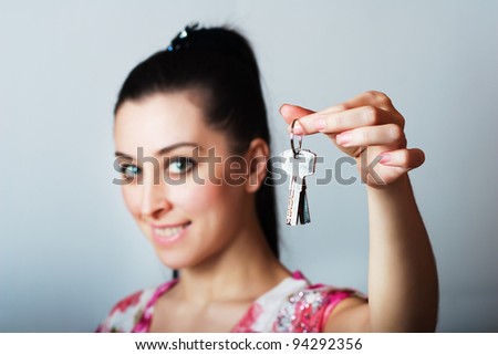 Realtor is giving the keys to an apartment to some clients. focus on the keys