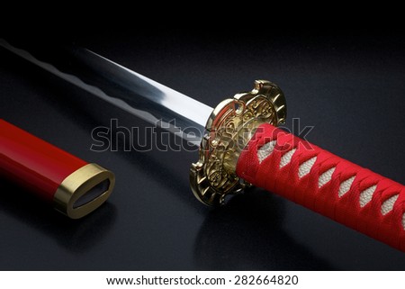 Japanese samurai sword and sheath against a dark background
