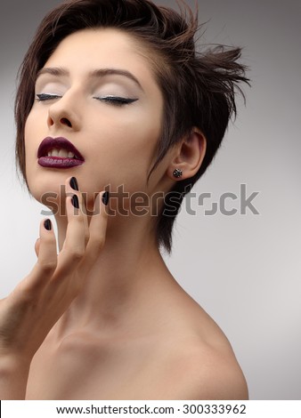 Beauty Vogue Style Fashion Model Girl with  Black Manicure it is isolated on a gray background. Fashion Trendy Caviar Black Manicure. Nail Art. Passion