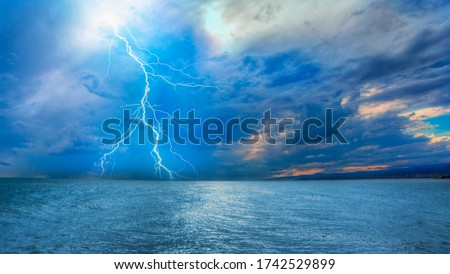 Beautiful landscape with lightning over the calm sea at sunset  商業照片 © 