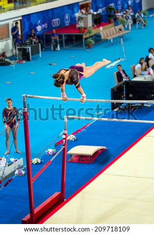 MERSIN, TURKEY - JUNE 21: Maria Trichopoulou, Greece performs exercise on uneven bars during International Tournament in Artistic Gymnastic Mediterranean games Mersin, Turkey on June 21, 2013