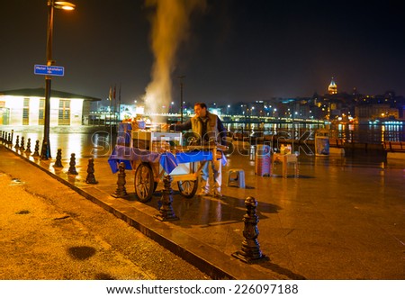 ISTANBUL - OCTOBER 22: Turkish man sells deep fried fish to tourists at Eminonu on October 22, 2014 in Istanbul.