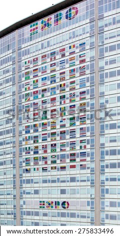 MILAN, ITALY- MARCH 24, 2015: EXPO 2015 logo and national flags on the Pirelli skyscraper in Milan. Expo Milano 2015 is the Universal Exhibition that Milan