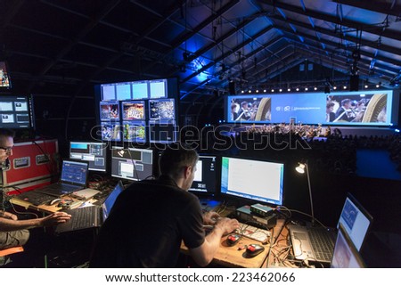 GENEVA, SWITZERLAND -SEPTEMBER 19, 2014: Technicians work at a concert by the UN Orchestra conducted by Antoine Marguier at the 60th anniversary of CERN the European Organization for Nuclear Research