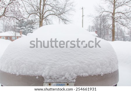 OTTAWA, CANADA Â?Â? FEBRUARY 21, 2015:  A car covered in heavy snow. Reports indicate that Ottawa has had the most days with temperatures below -15 C in 2015 since 1888.