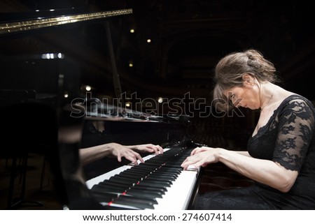 GENEVA, SWITZERLAND - MARCH 21, 2014: Pianist Elisso Bolkvadze rehearses with the UN Orchestra conducted by Antoine Marguier at the Spring Concert 2014 in the Victoria Hall.