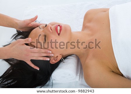 masseuse does relax facial massage to the girl