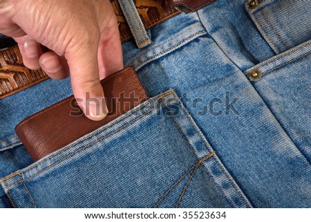 hand of the thief in pocket jeans
