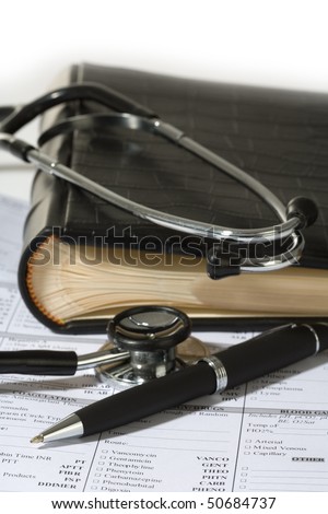 Stethoscope, a pen and a blank prescription pad