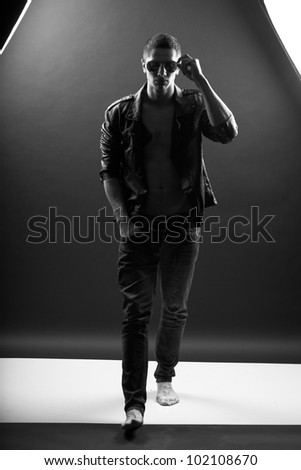 Young man walking in darkness
