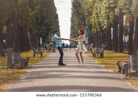 Young couple dancing in park