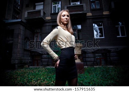 Portrait of sexy fashionable girl posing on street