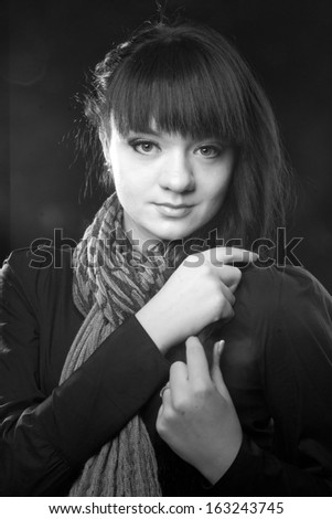 Black and white portrait of woman with long black hair and grey scarf