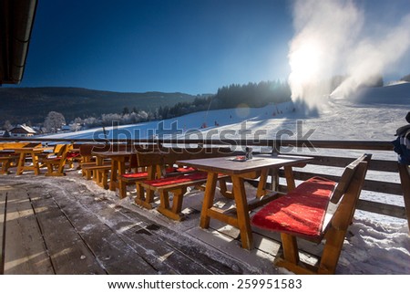 Traditional restaurant with open terrace on ski resort at sunny day