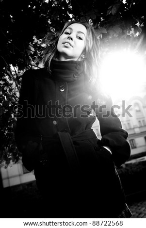 Black and white portrait of young girl posing in sun ray