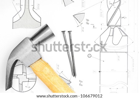 Hammer and nails on the drawing.