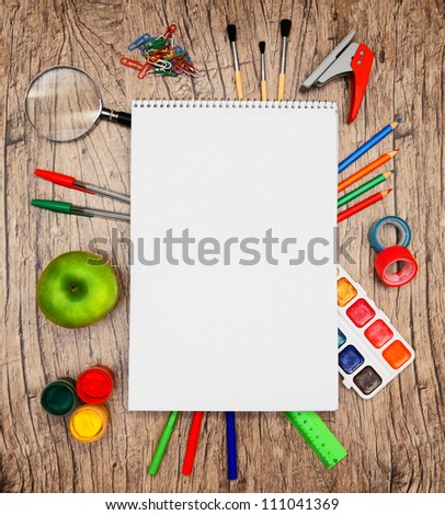 Back to school. Writing tools. On a wooden background.