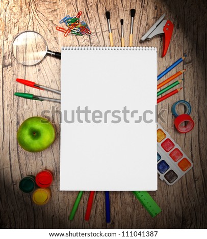 Back to school. Writing tools. On a wooden background.