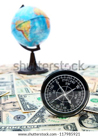 Travel. A compass and the globe on money.