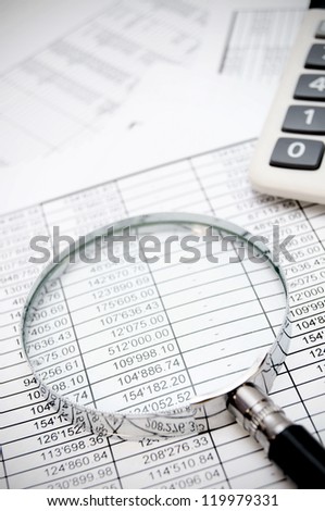 Calculator and magnifier on documents.