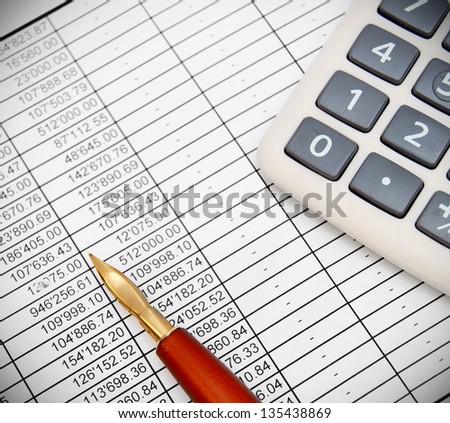 The calculator and pen on documents.