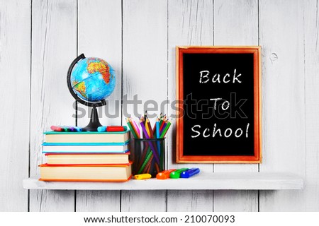 Back to school. Frame. Books and school tools on a wooden shelf.