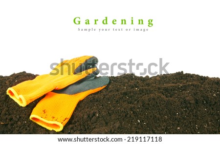 Gardening. Gloves on the earth, on a white background.