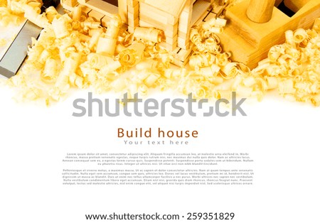 Woodworking. House construction. Joiner's works. The wooden house, chisel, plane and shaving on white background.